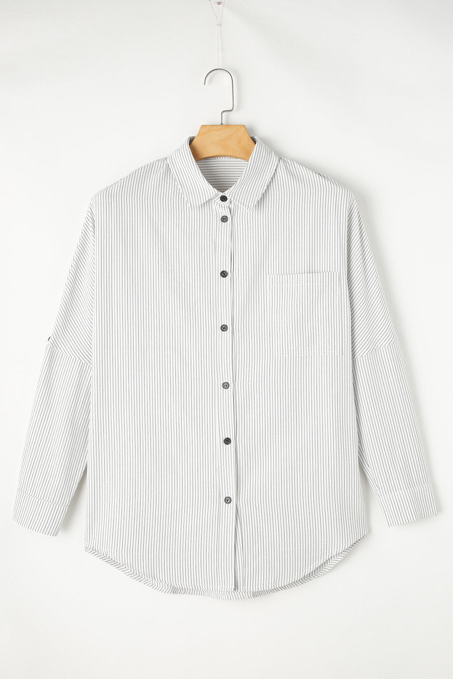 Relaxed white button-down shirt with vertical pinstripes and a chest pocket.