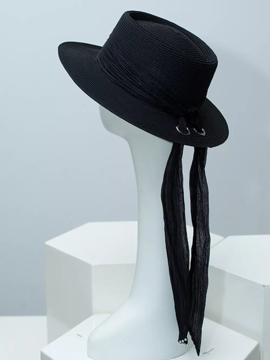 Black straw sun hat with ribbon detail and silver rings