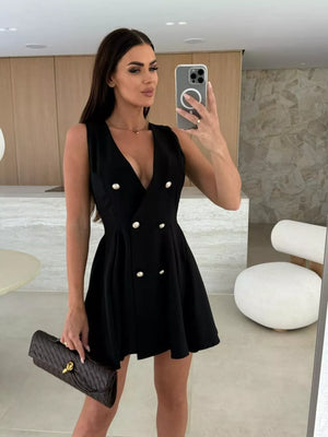 Black double-breasted mini dress with gold buttons and pleated skirt.