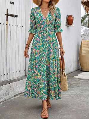 Vibrant V-neck flounce sleeve maxi dress in abstract print with tiered skirt and lace trim.