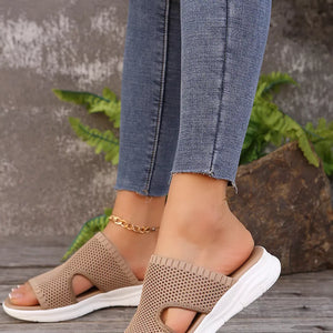 Khaki mesh slide sandals with open toe and white sole.