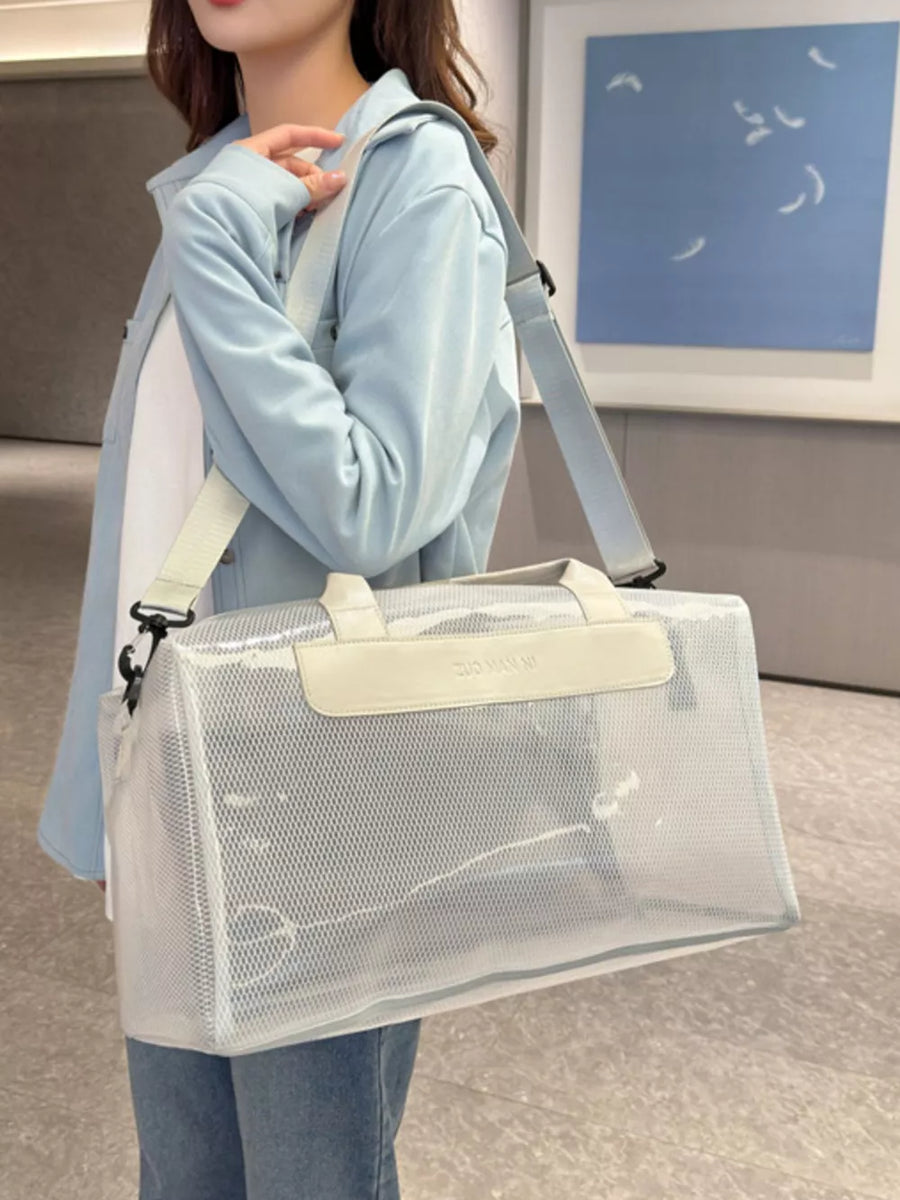 Chic transparent PVC travel bag in off-white with mesh details and dual handles.