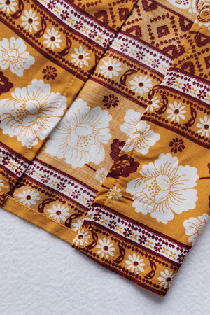 Bohemian floral print crop top and maxi skirt set in viscose, featuring a yellow base with white and maroon floral patterns.
