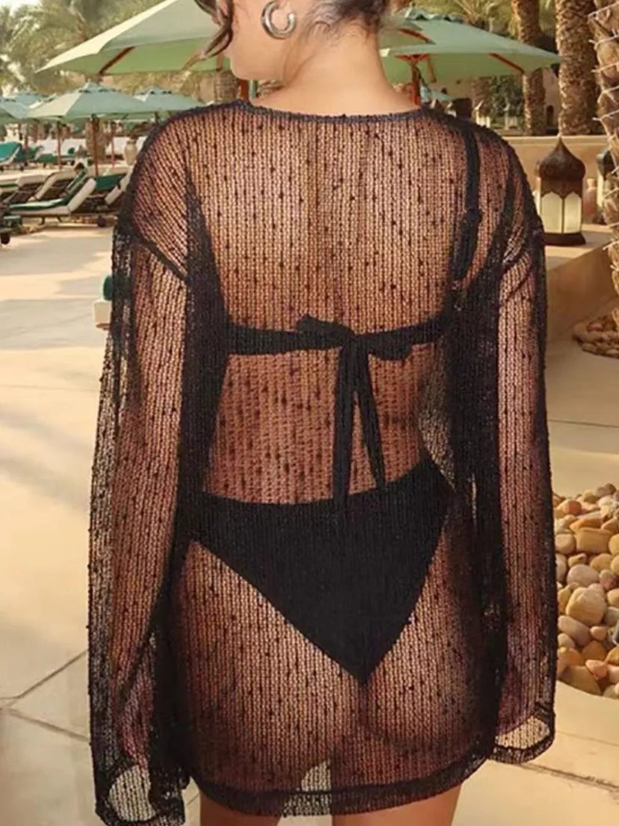 Black sheer knit cover-up with polka dots and tie back detail.