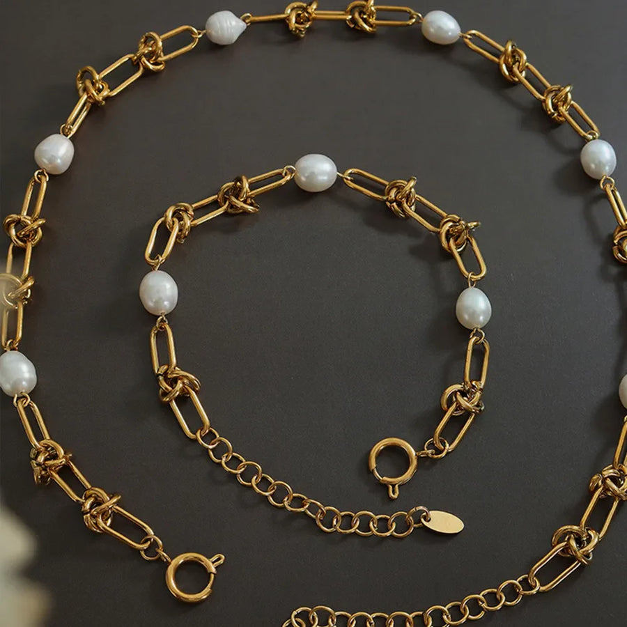 Gold linked pearl knot collar necklace with toggle clasp and extender chain.