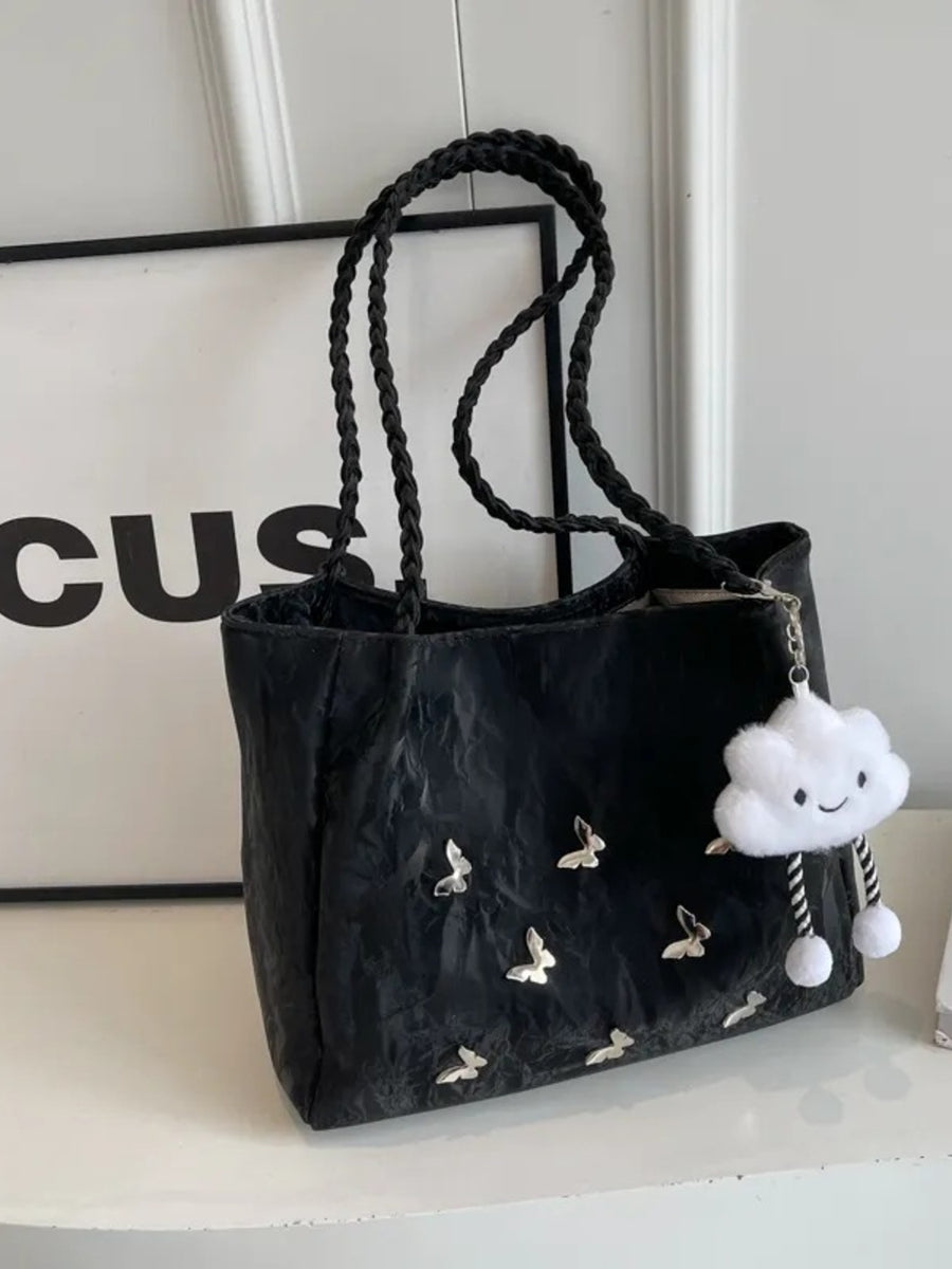 Black shopper bag with braided handles, butterfly details, and cloud charm