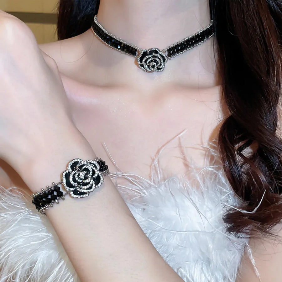 Black rose petal embellished bracelet with crystal accents and beaded details.