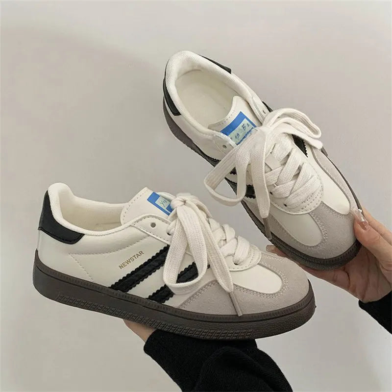 Retro suede trainers in white and grey with black signature stripes and white laces.