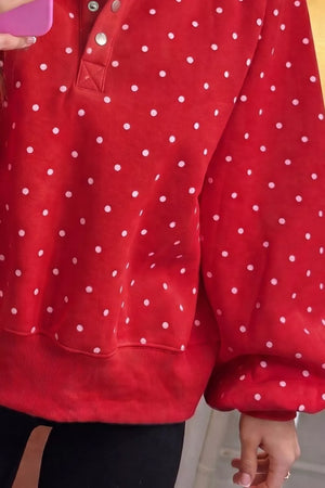 white sweatshirt featuring buttoned and polka dot
