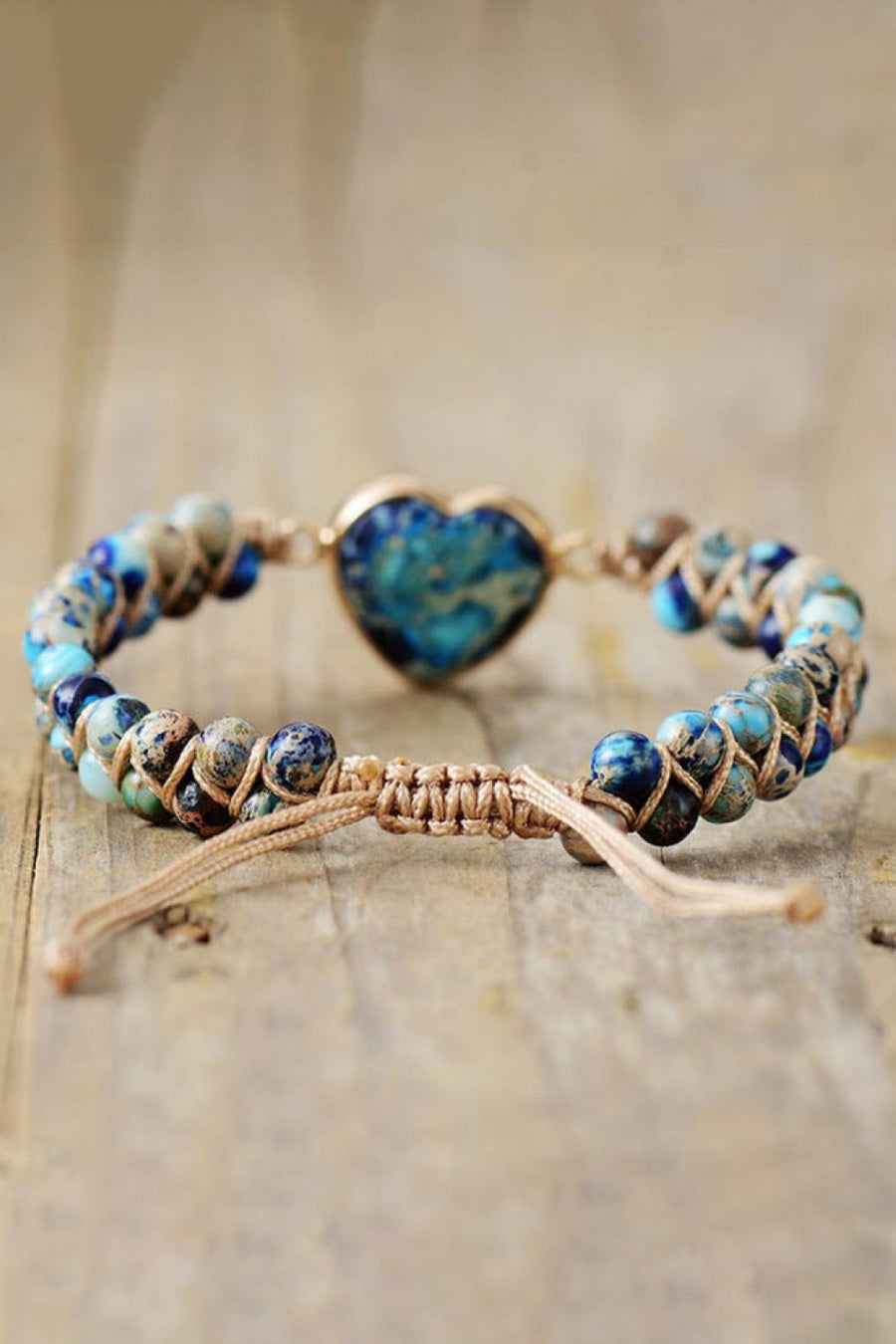 Braided bracelet with blue marbled heart stone and assorted blue and tan beads