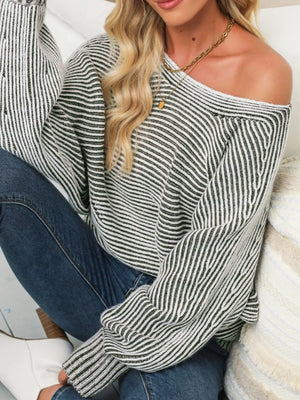 Relaxed ribbed knit sweater with boat neck and stripe pattern in black and white.
