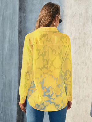 Yellow sheer button-down blouse with floral embroidery and a collared neckline.