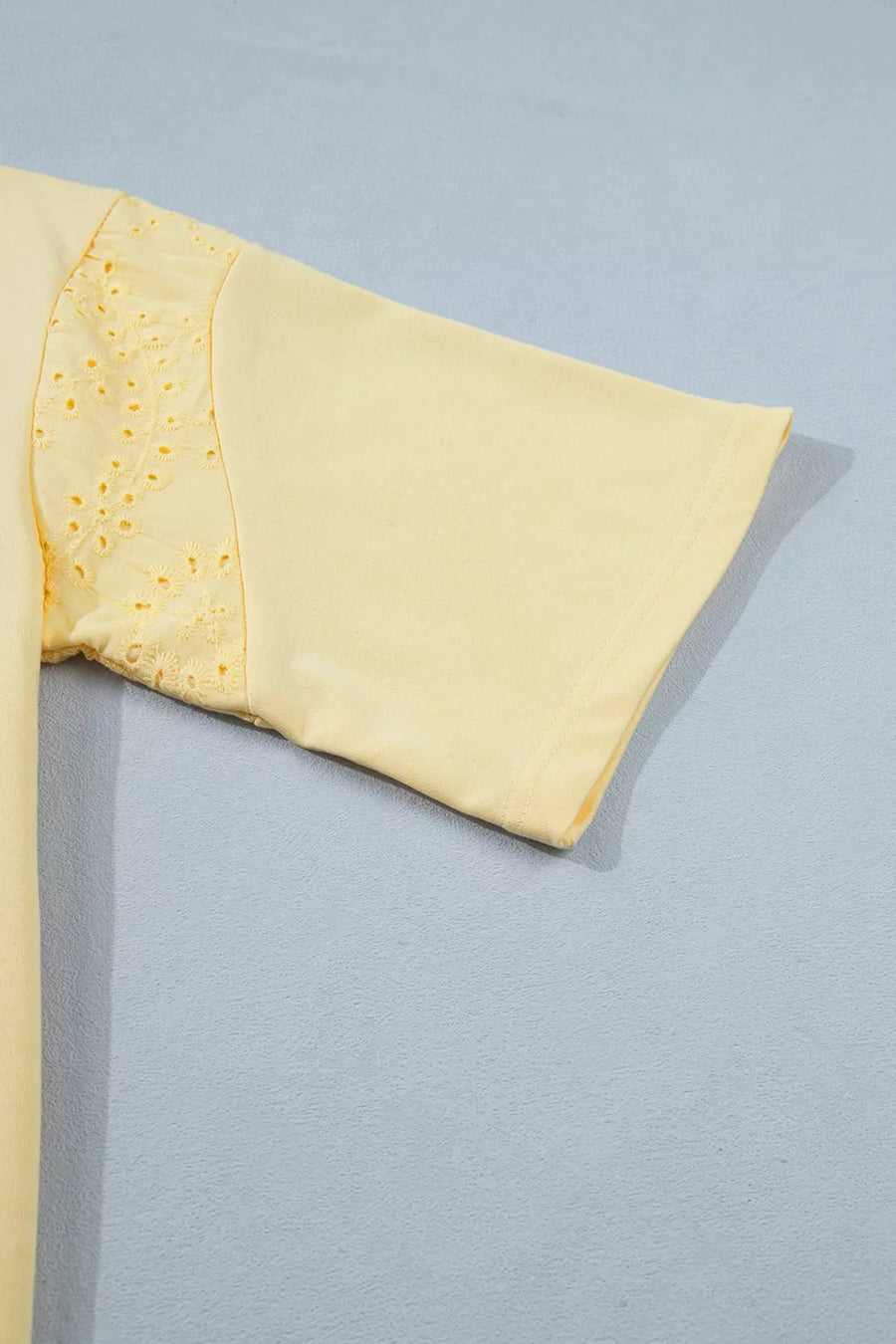 Yellow cotton half-sleeve top with eyelet lace detail on the sleeve.