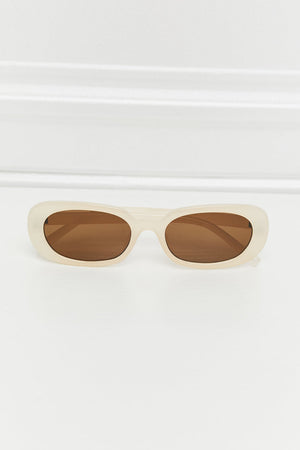 Cream oval sunglasses with sunset brown lenses and a matte finish.