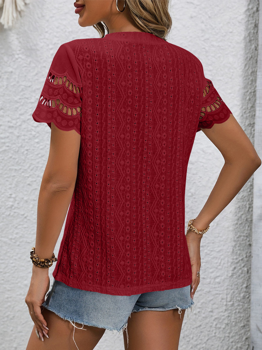 Burgundy eyelet blouse with scalloped short sleeves and intricate patterned fabric.