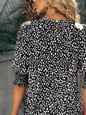Black animal print half sleeve blouse with smocked cuffs and puff sleeves.