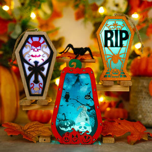 Spooky Silhouette Lantern Trio Ornaments: pumpkin, coffin with skull, RIP coffin with spider.