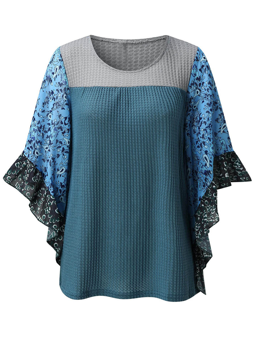 Textured panel blouse in Dusty Blue with gray and floral print flutter sleeves.