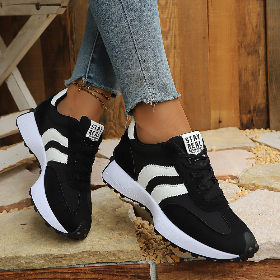 white sneakers featuring round toe and striped