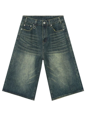 Wide-leg distressed denim culottes in a vintage blue wash with a buttoned fly and metal D-ring detail.