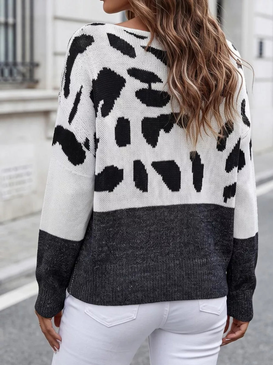 black pullover sweater featuring one-shoulder and cow-print