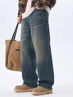 Men's relaxed fit wide-leg jeans in washed blue denim with a faded look.