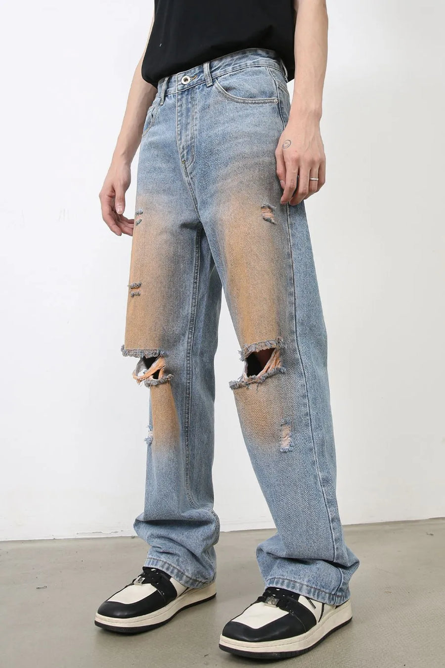 Light blue wide leg denim jeans with faded wash, distressed details, and ripped knees.