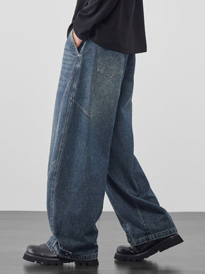 Men's baggy vintage wash jeans in dark blue denim with cinched hems.