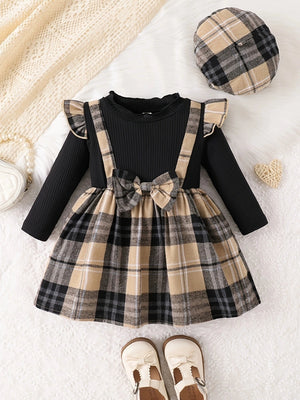 Baby girls' black long sleeve plaid dress and hat set with ruffled details and bow.