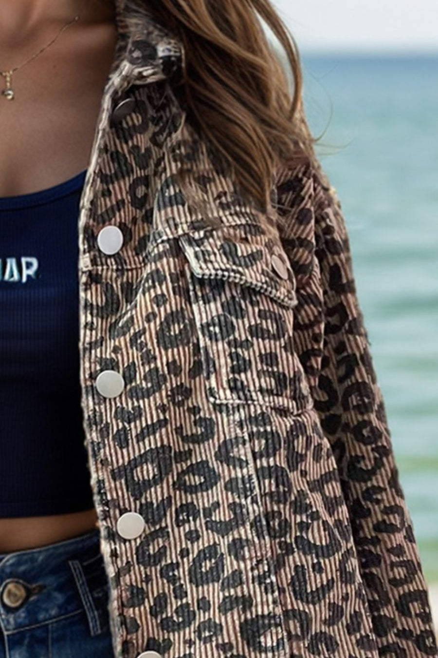 Leopard print corded cropped jacket with button front and chest pockets.