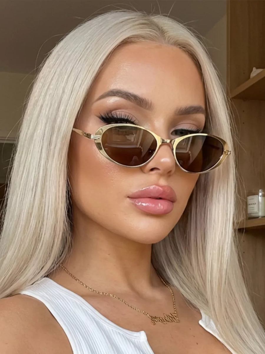 AC Frame material: Metal Lens material: Polycarbonate Temple material: Metal Imp sunglasses in black with oval silhouette