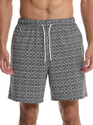 Black geometric print boardshorts with white drawstring and elastic waistband.