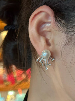 Silver earrings with pearl and zircon details, featuring a unique fan design.