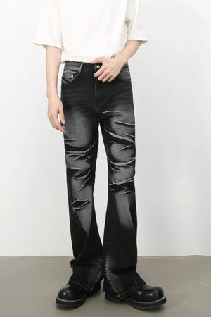 Distressed flare jeans in dark shadow wash denim with a bootcut leg and subtle rips.