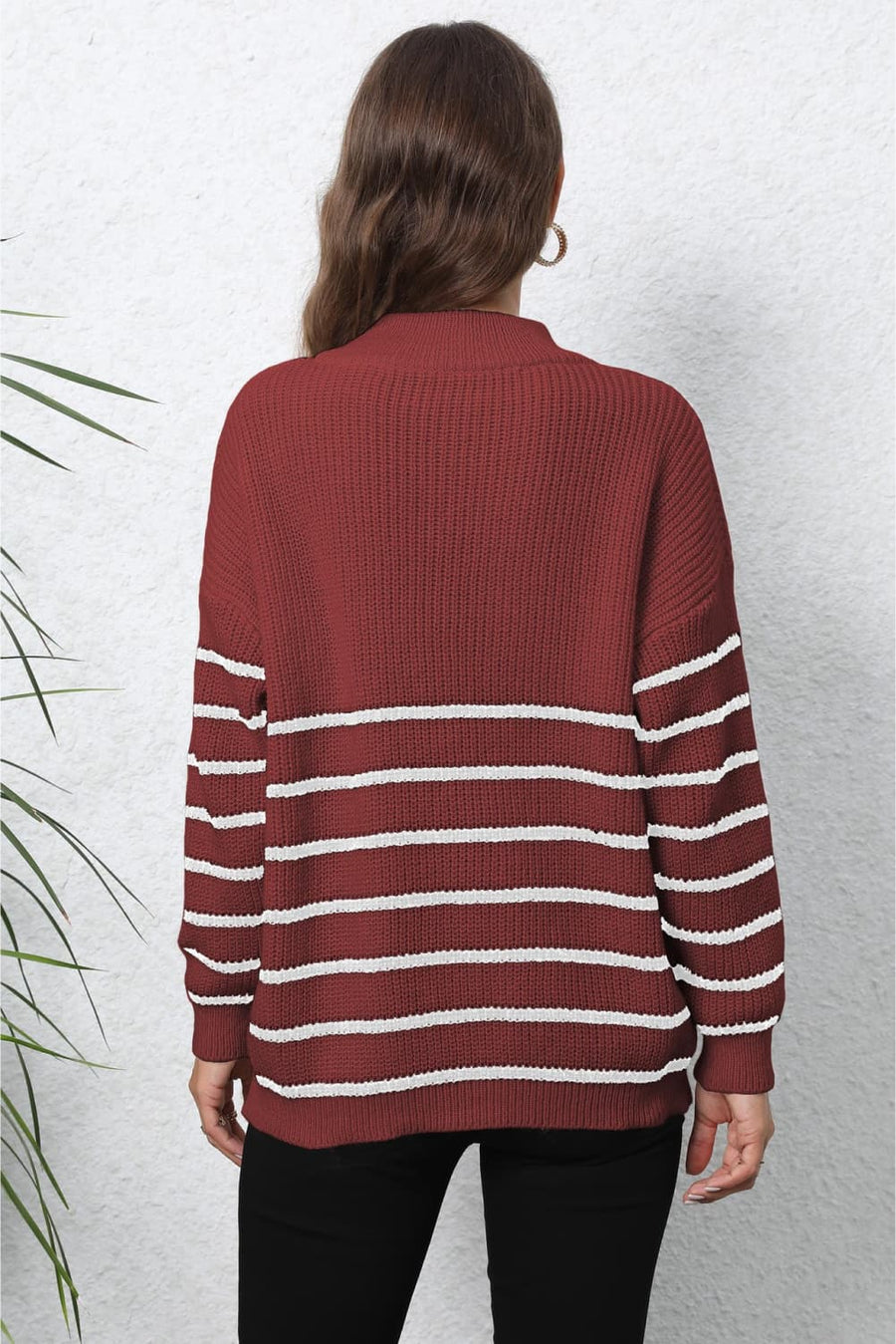 Burgundy knit sweater with white horizontal stripes and a mock neck.