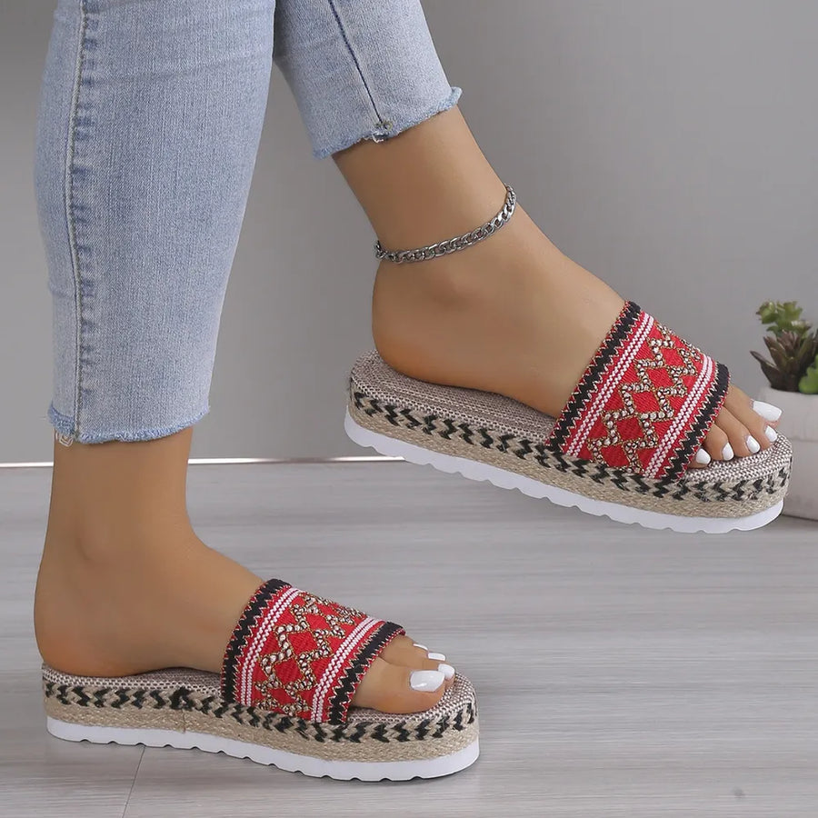 Embroidered platform espadrille slides in deep red with woven jute and zigzag trim.