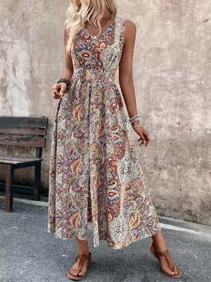 Vibrant paisley print maxi dress with cinched waist and dramatic slit.