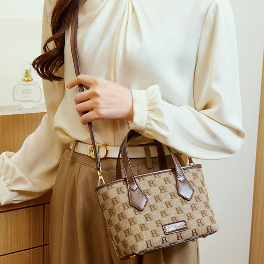crossbody bag in tan with monogram and top handles