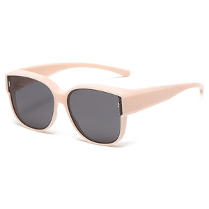 Oversized blush pink cat-eye sunglasses with dark lenses and UV protection.