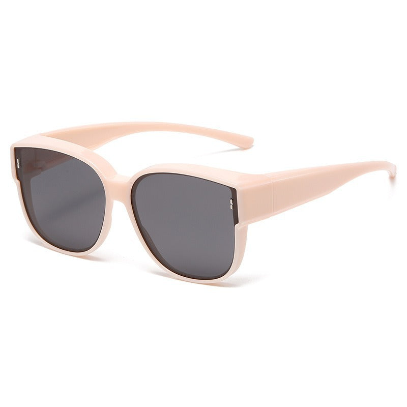 Oversized blush pink cat-eye sunglasses with dark lenses and UV protection.