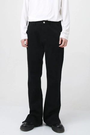 Flared hem denim trousers in dark cotton, styled casually.