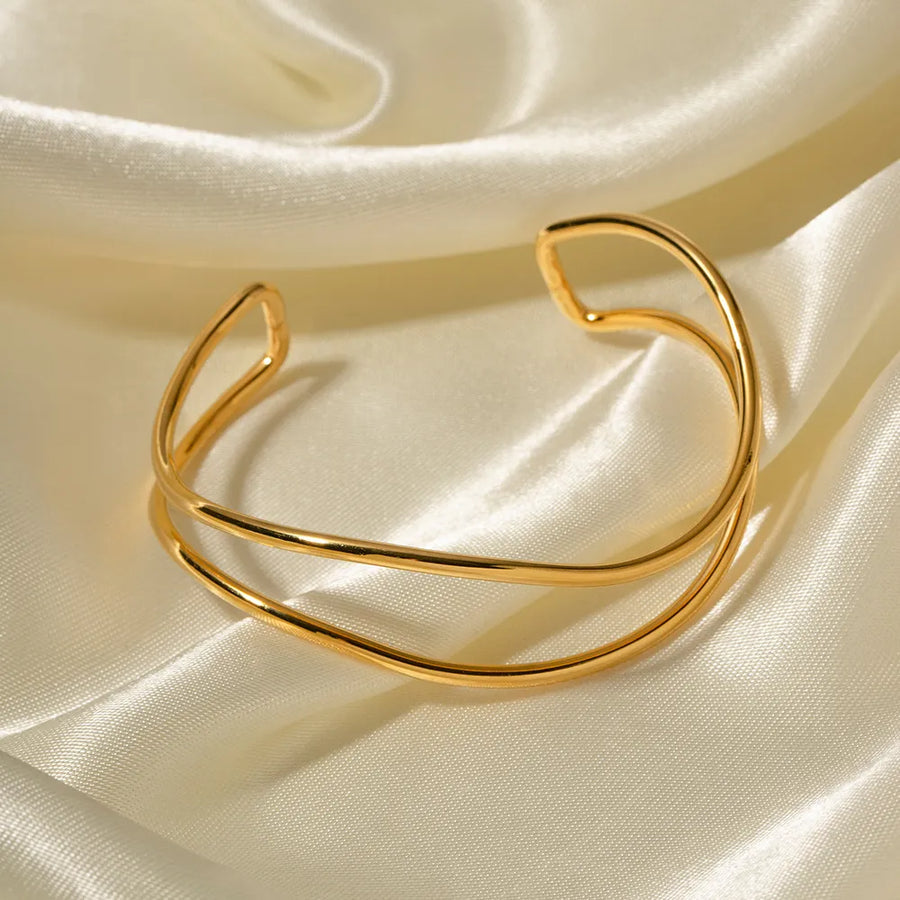 Gold double-band cuff bracelet with a smooth, polished finish.