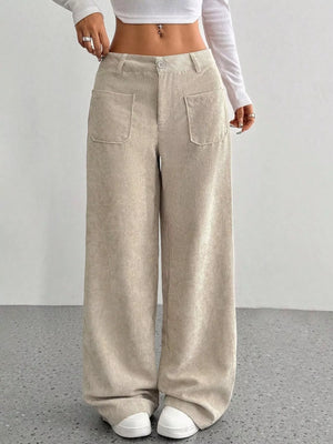 Chic wide-leg corduroy trousers in apricot with large front pockets and a comfortable fit.