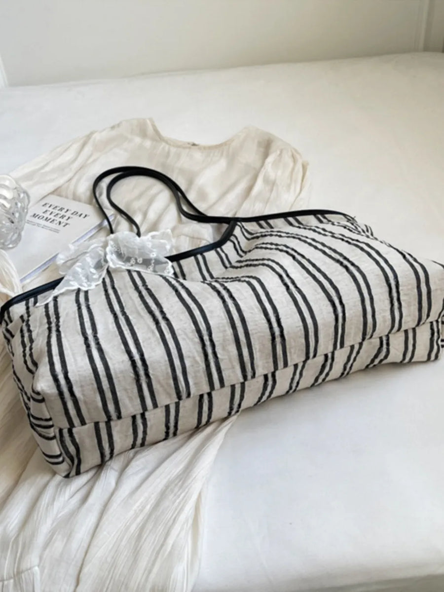 Beige shopper bag with black stripes and lace bow detail