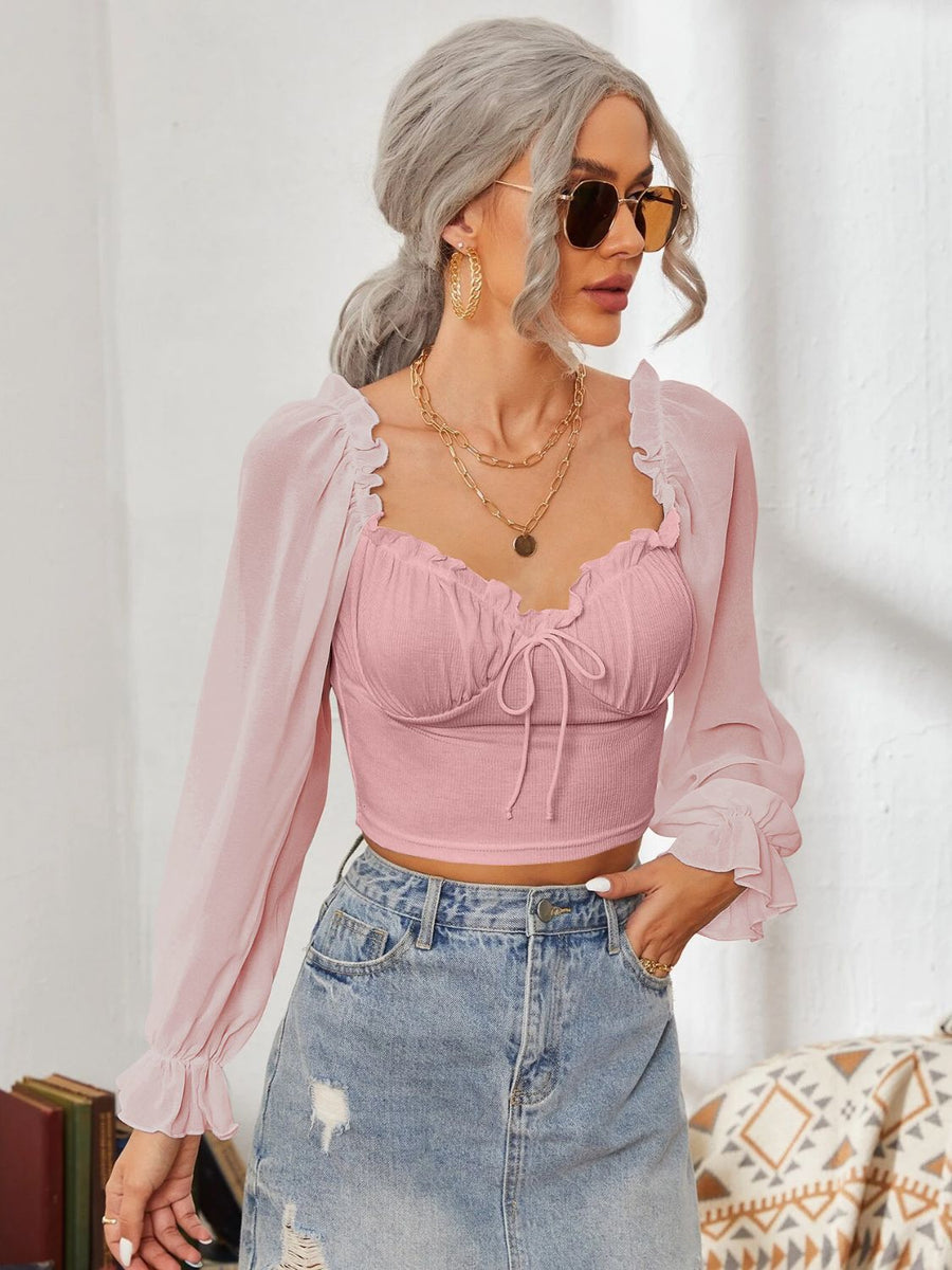 Pink bustier blouse with tie front and sheer ruffled sleeves