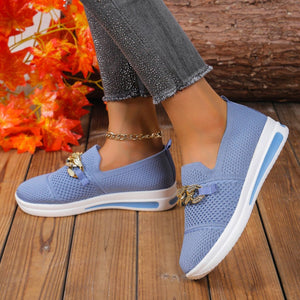 Sky blue mesh slip-on flats with chunky chain detail and white sole.