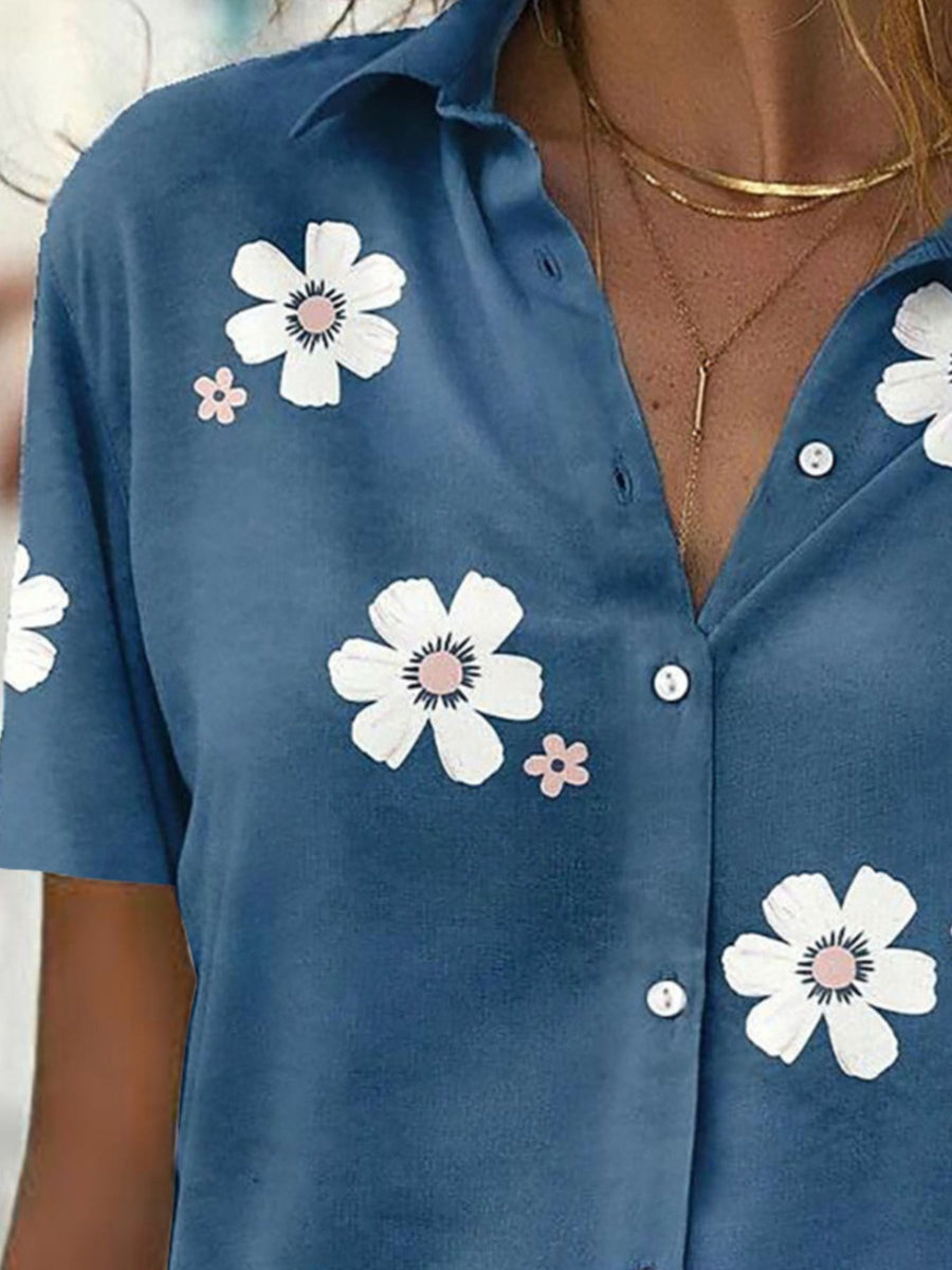white button-down shirt featuring buttoned and floral