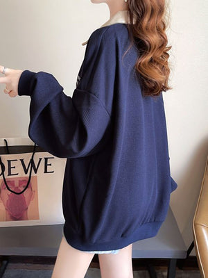 Navy waffle-knit polo sweatshirt with cuffed sleeves and a relaxed fit.