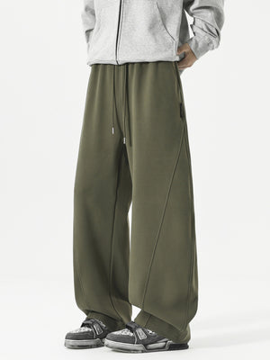 Men's relaxed fit army green sweatpants with drawstring and diagonal seam detail.
