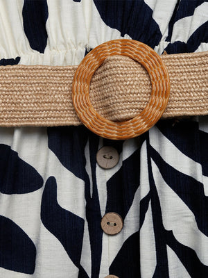 Belted dress with tropical leaf print, raffia belt, and decorative buttons.